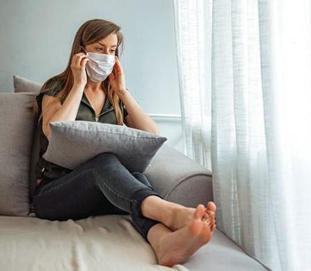 masked woman on couch image